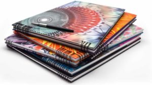 Composition notebooks with vibrant covers and spiral bindings